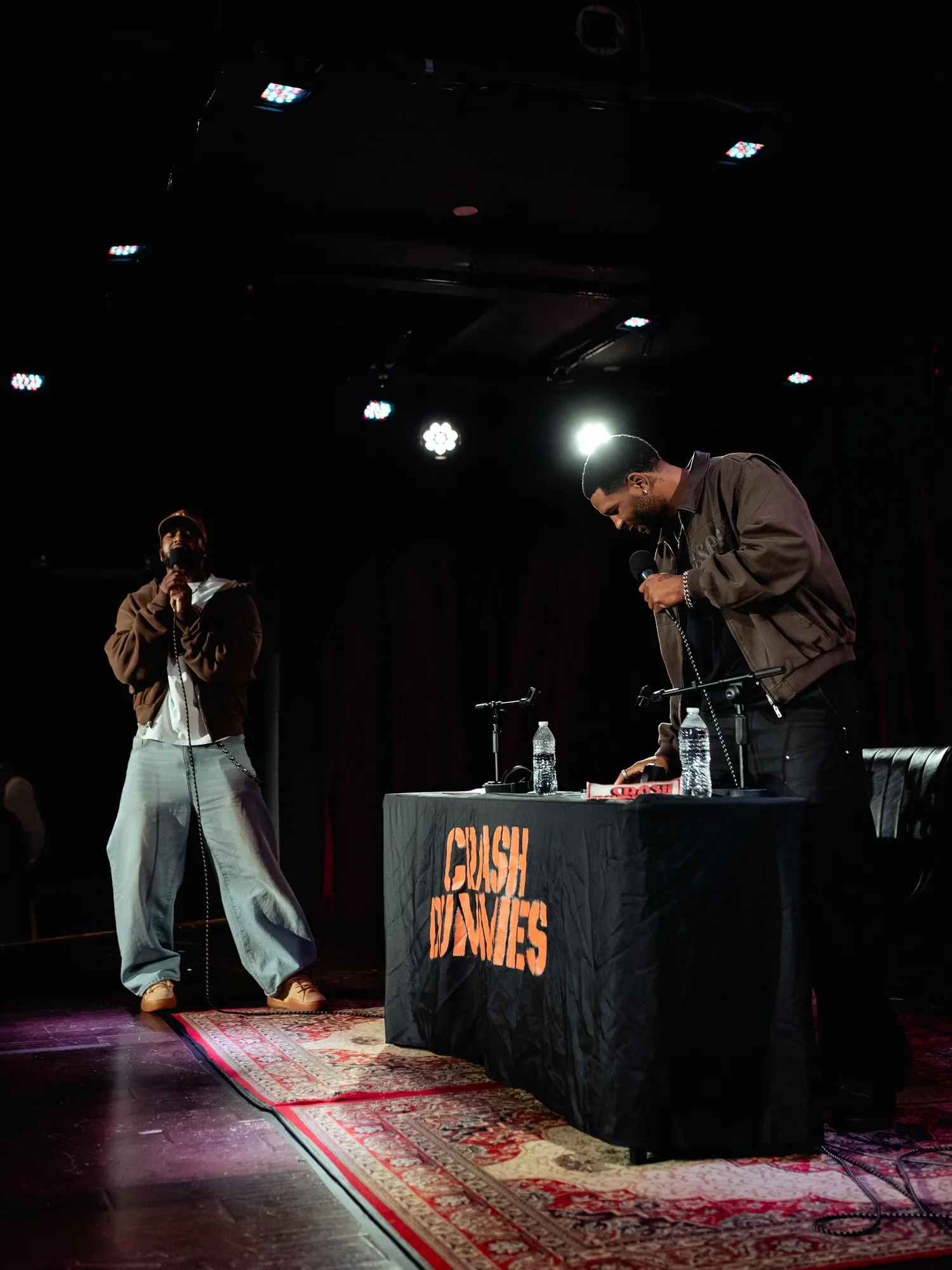 Both hosts on their feet on stage