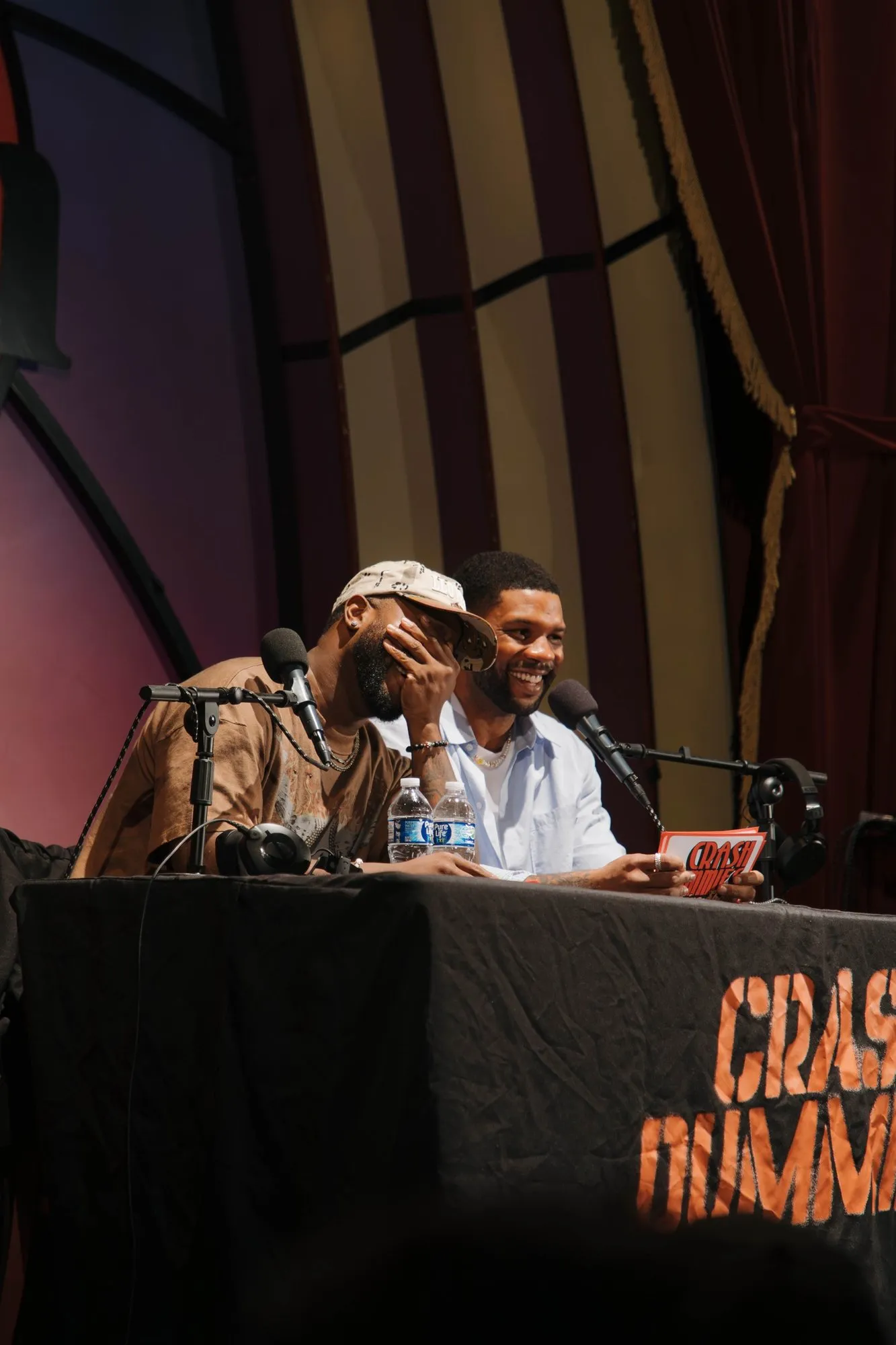 The hosts laughing at the desk
