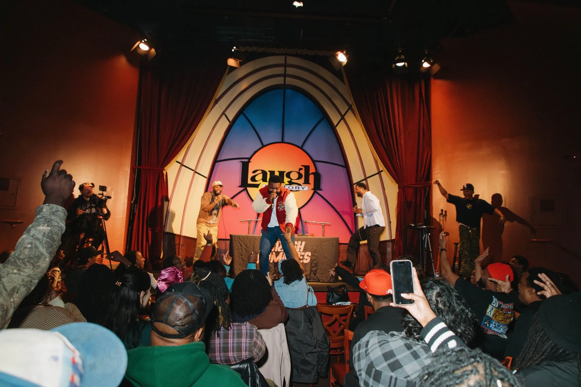 Fans with their hands up as the hosts take the stage