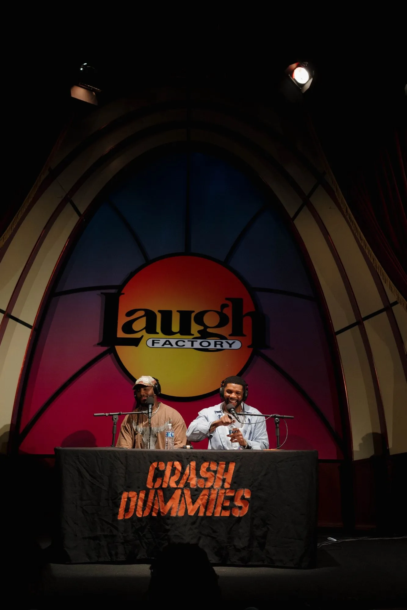 The hosts on stage seen from the back of the room