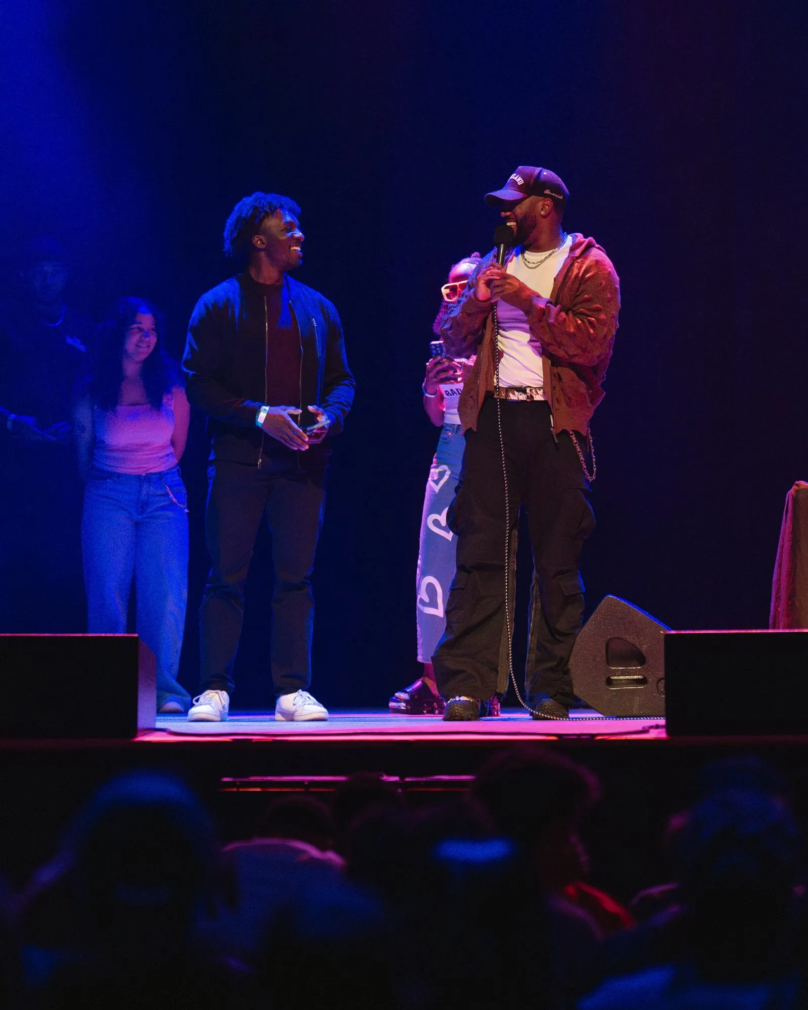 A host jokes with fans brought up on stage