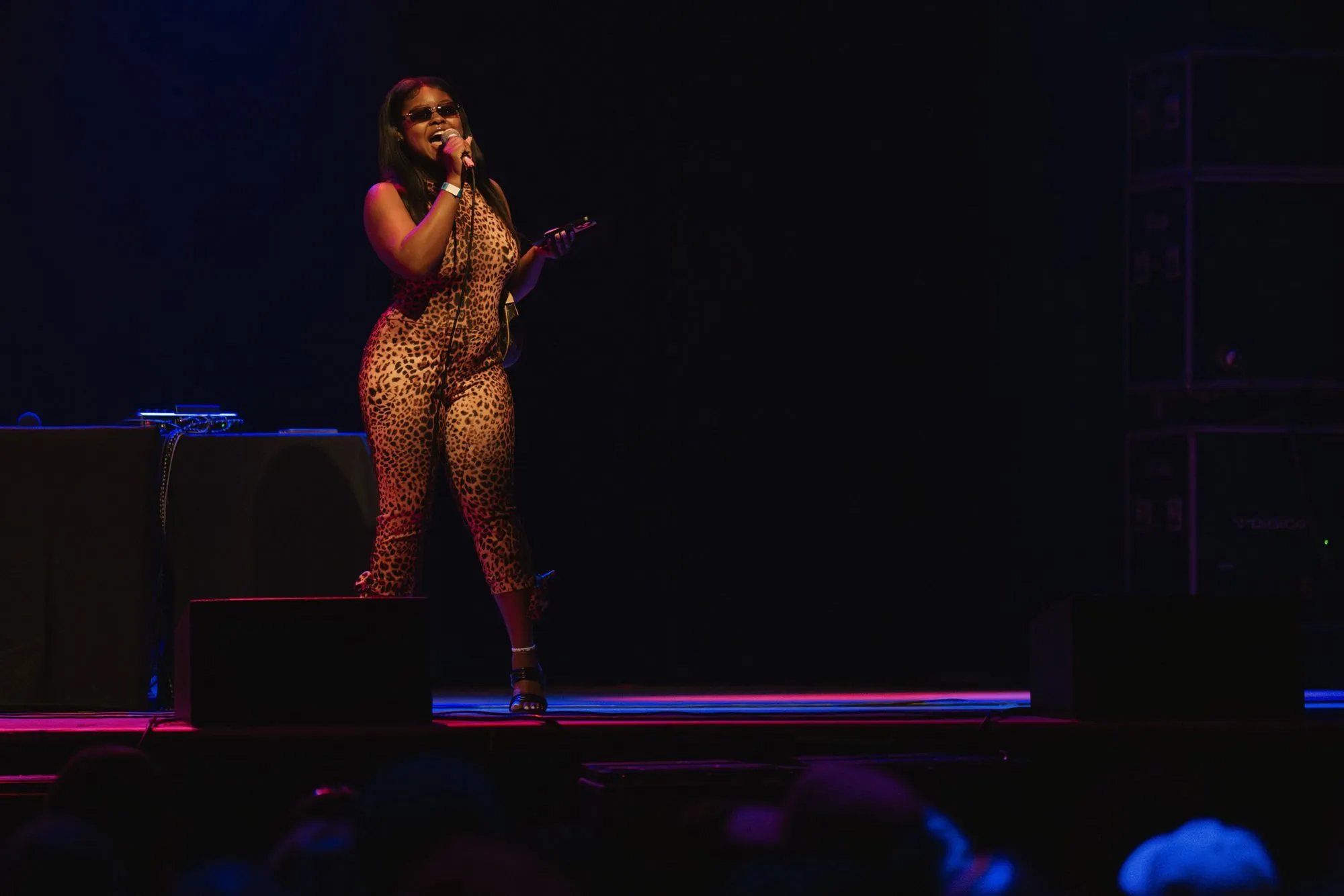 A fan in a leopard-print jumpsuit takes the mic