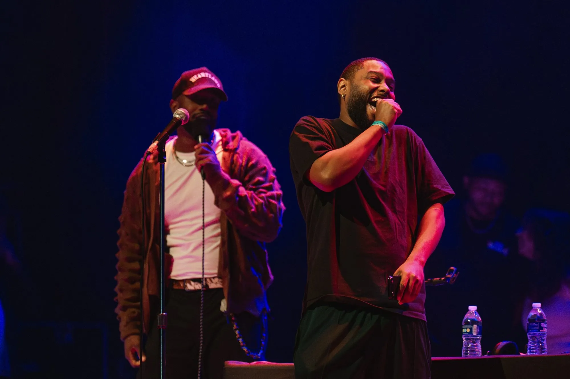 A host and a guest crack up on stage