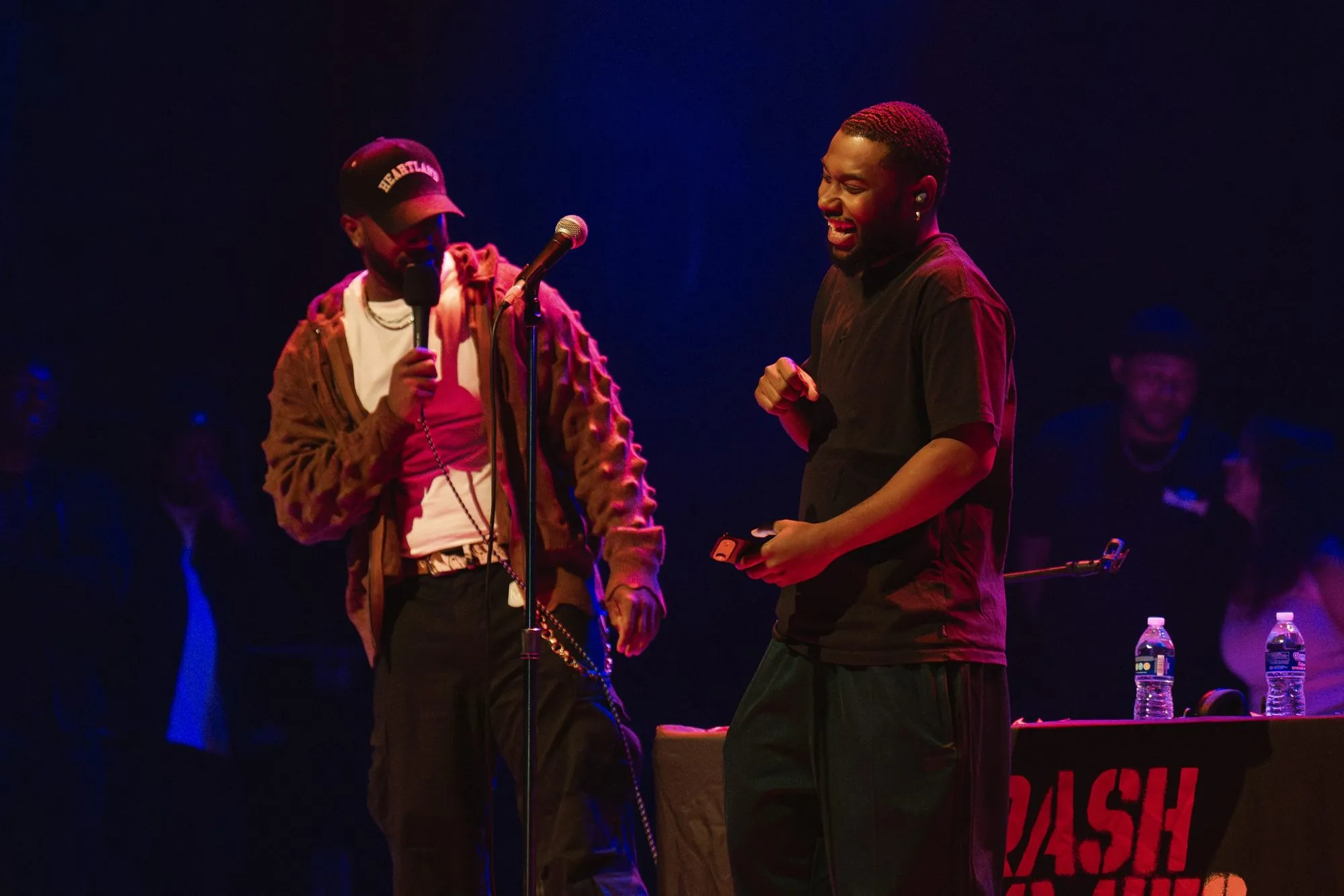 A guest laughs mid-bit next to a host