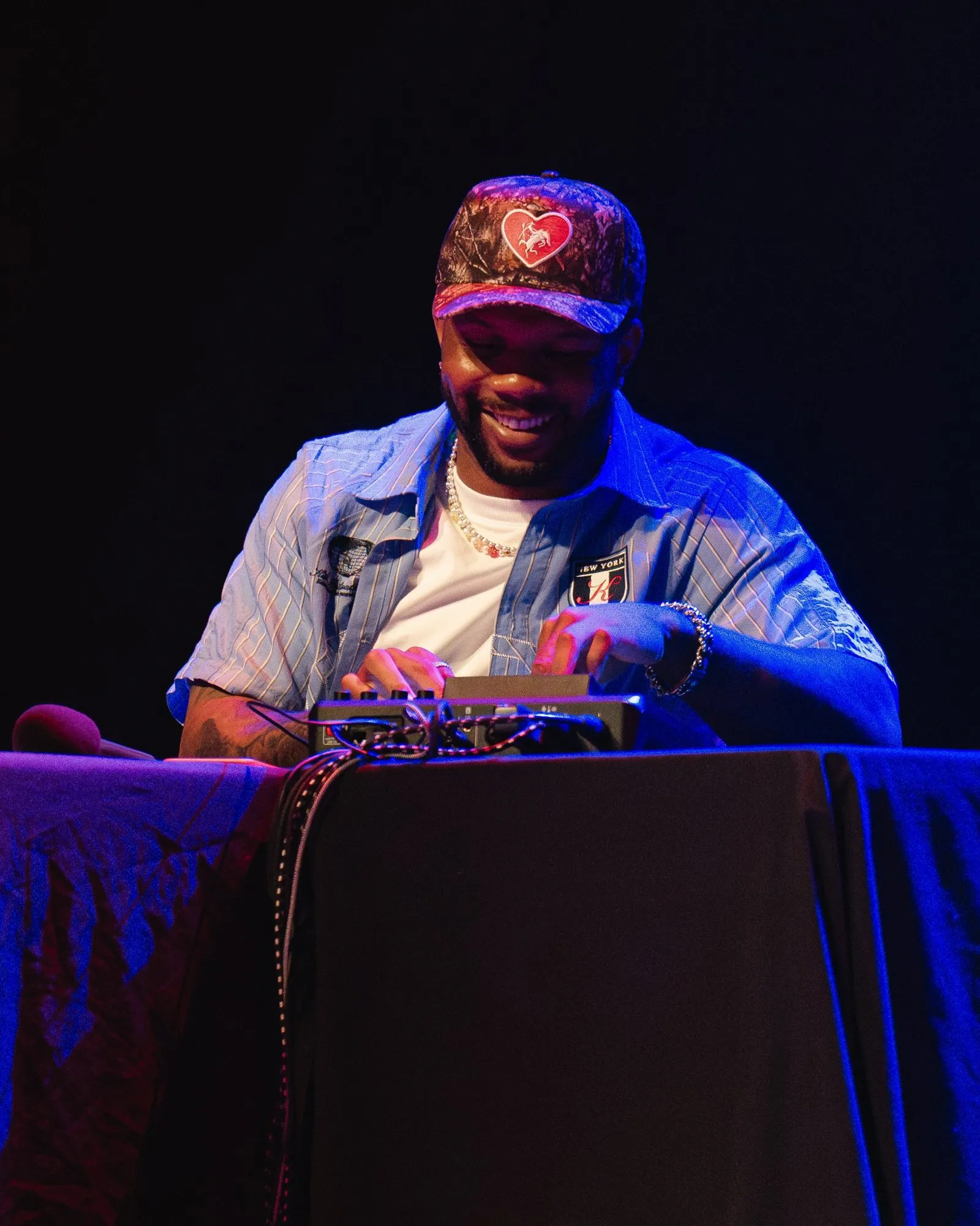 A host on the soundboard, smiling