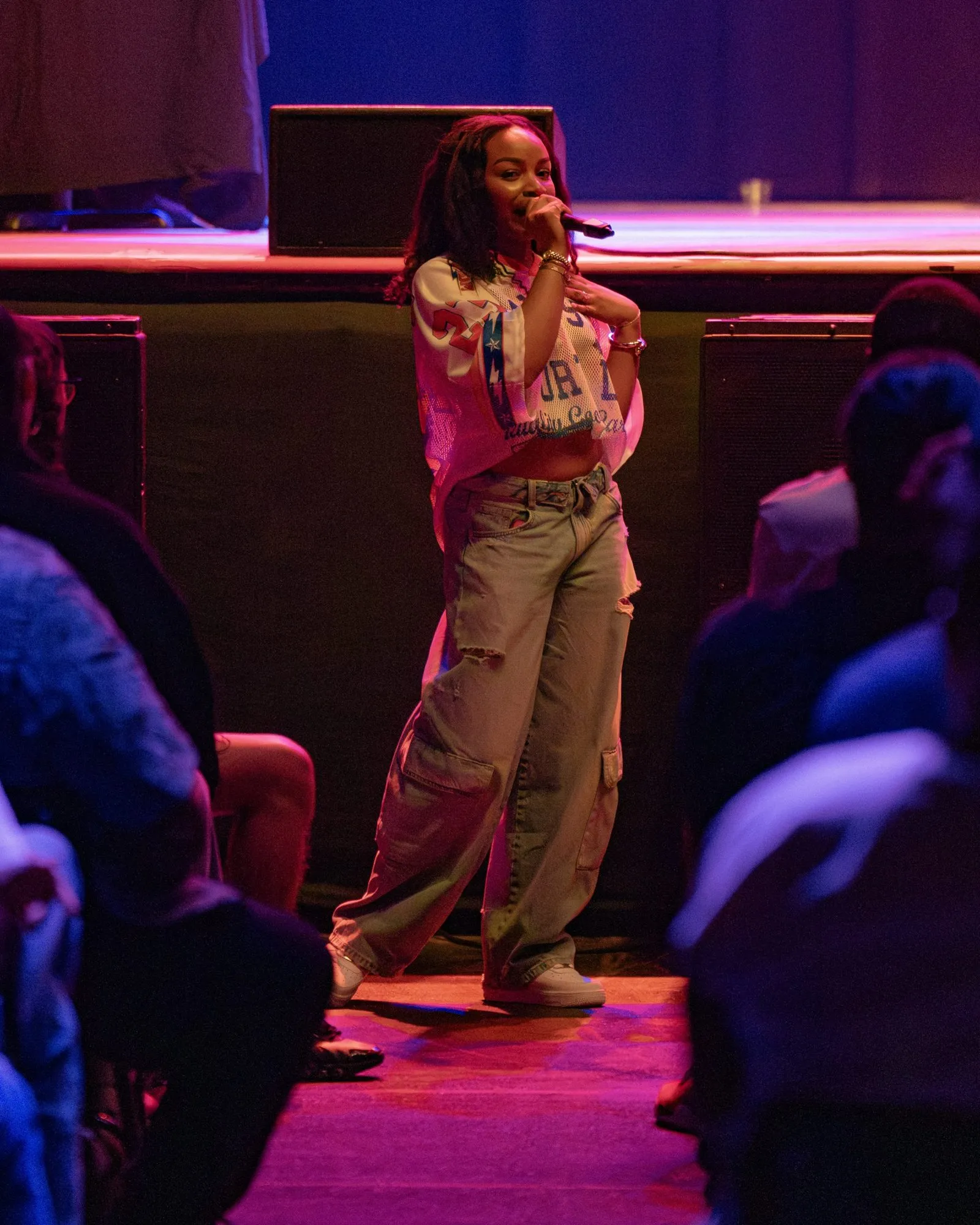 A fan takes the mic in the aisle in front of the stage