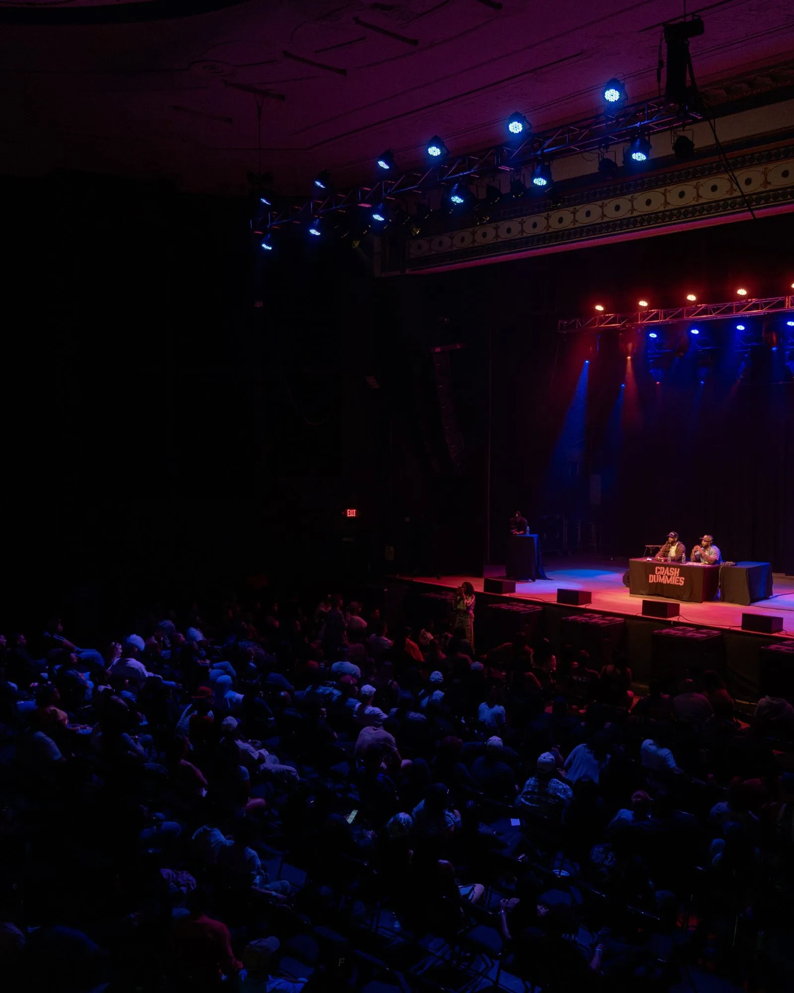 Overhead view of the packed Majestic crowd facing the Crash Dummies desk on stage