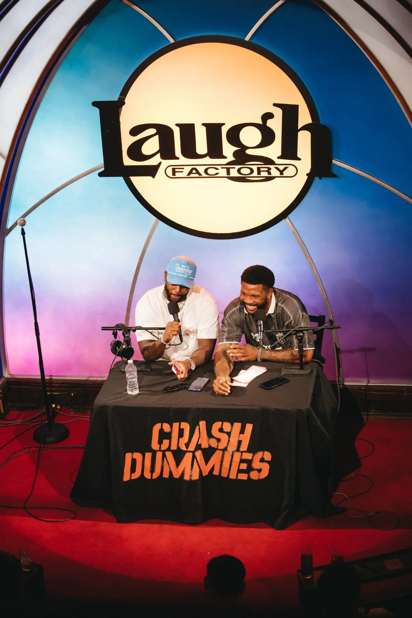 Mike and Pat at the Crash Dummies desk on the Laugh Factory stage