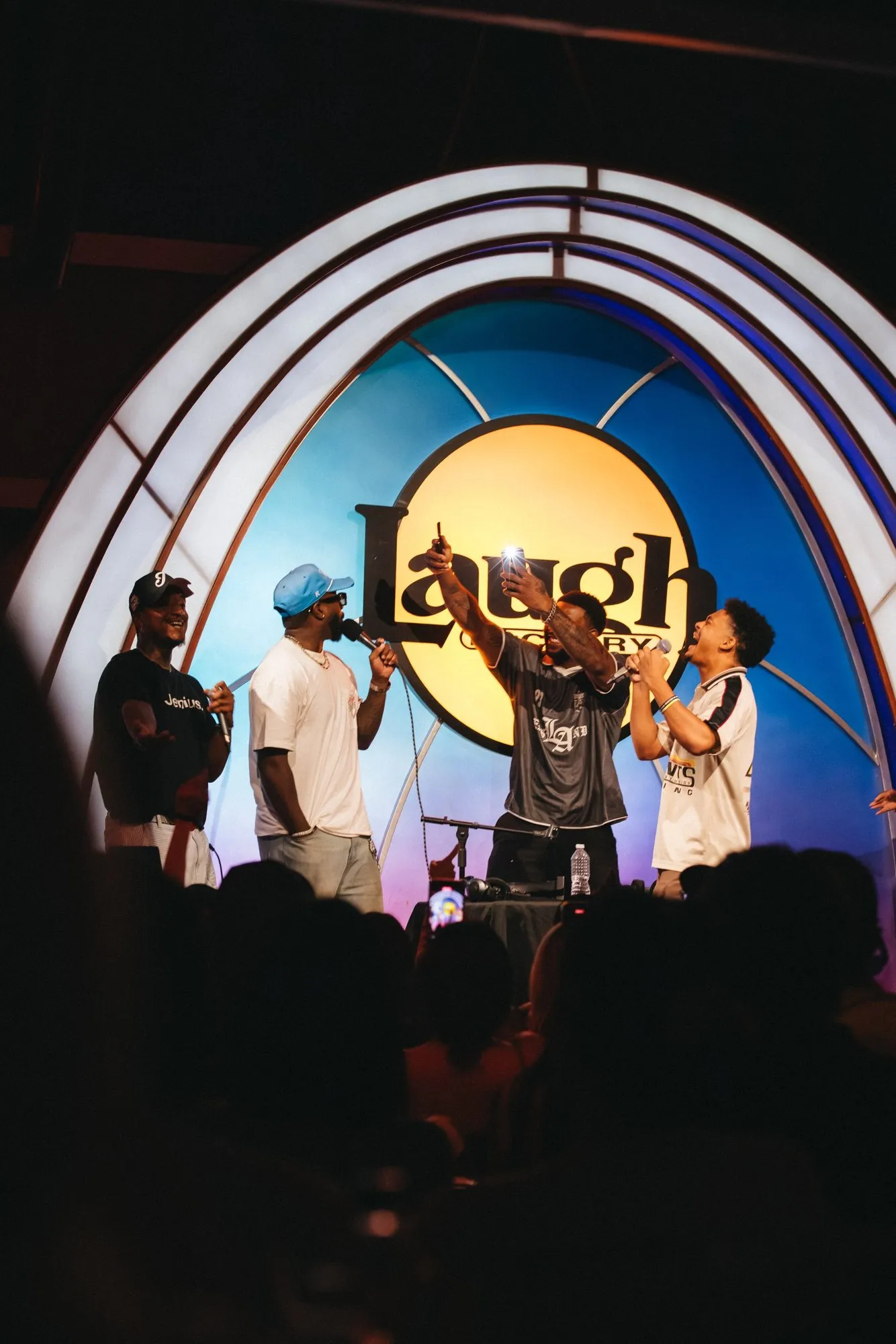 Guests line up on stage under the Laugh Factory sign