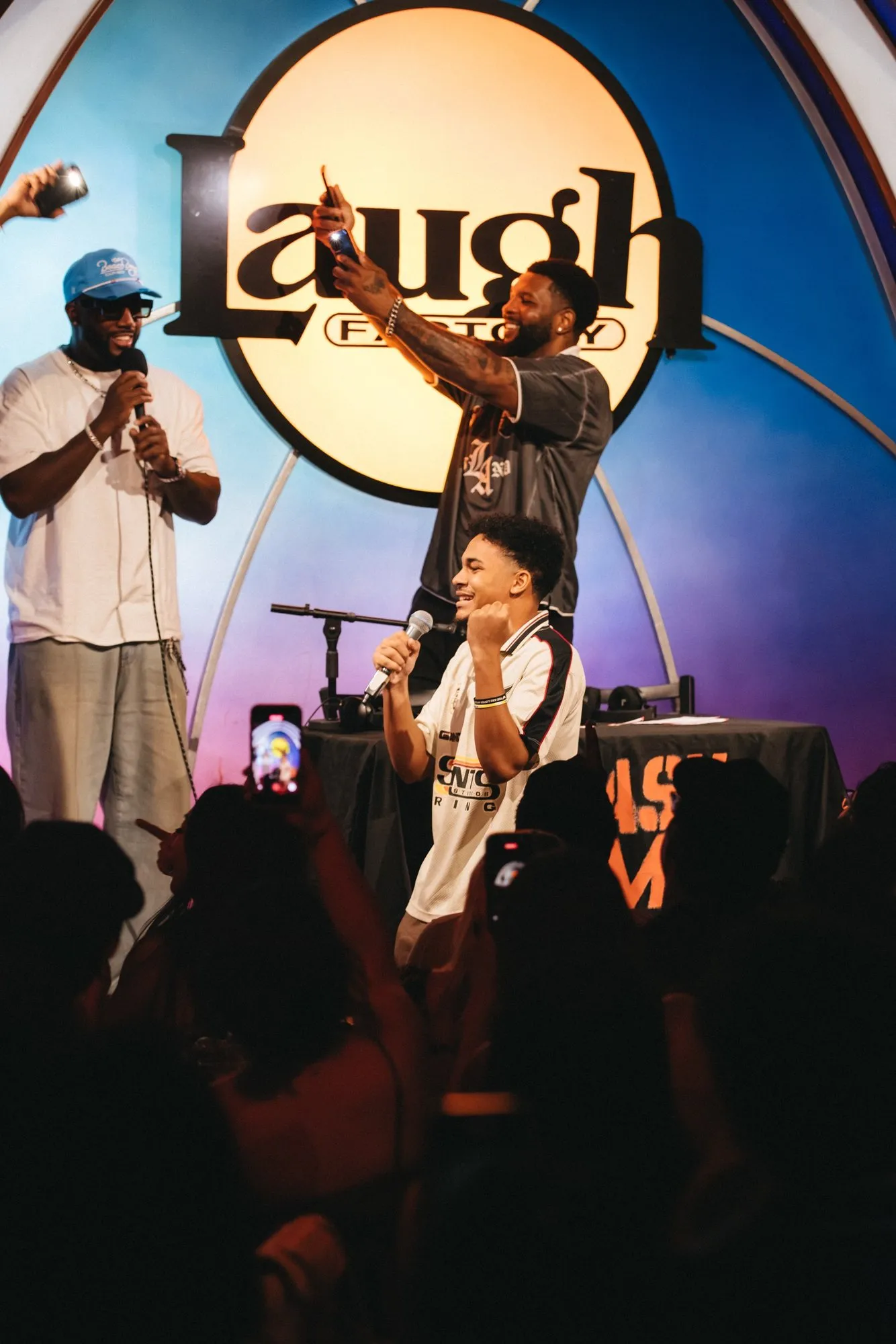 A host and a fan on stage with the mic